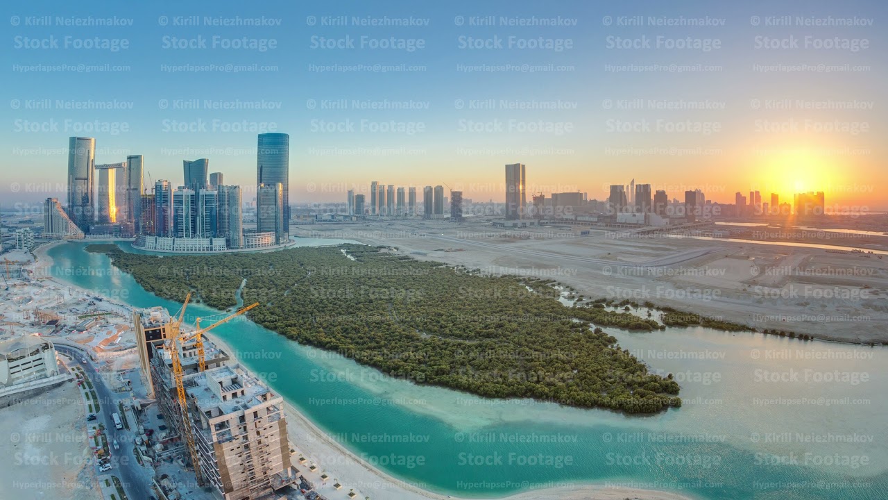 Buildings on Al Reem island in Abu Dhabi at sunset timelapse from above.