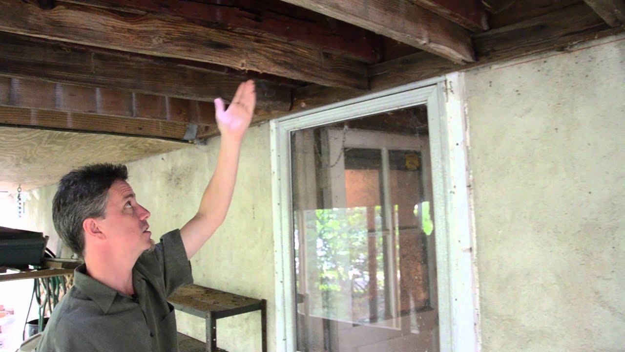 A disater waiting to happen! A deck with a glass structure on top near collapse DeckRemodelers.com