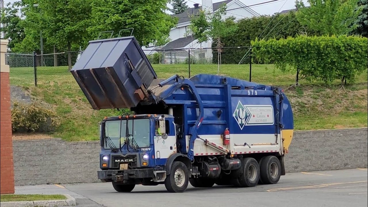 Several Front Loader Garbage Trucks In Action