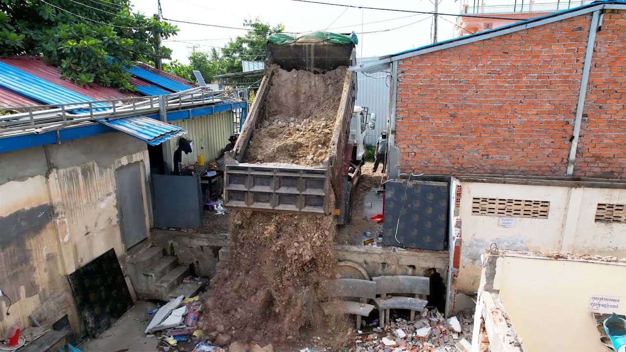 Bulldozer destroy the old home and fill up the soil