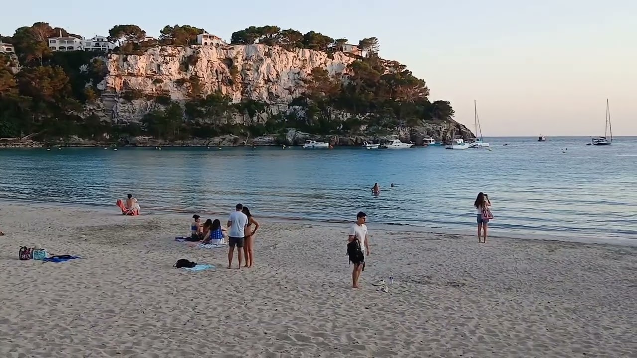 Cala Galdana June 2025. People watching on the beach at 9 pm.