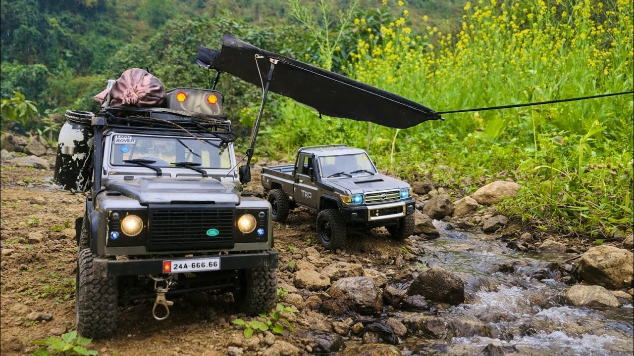 Remote-controlled vehicles climb hills and mountains together, conquering mountainous terrain.