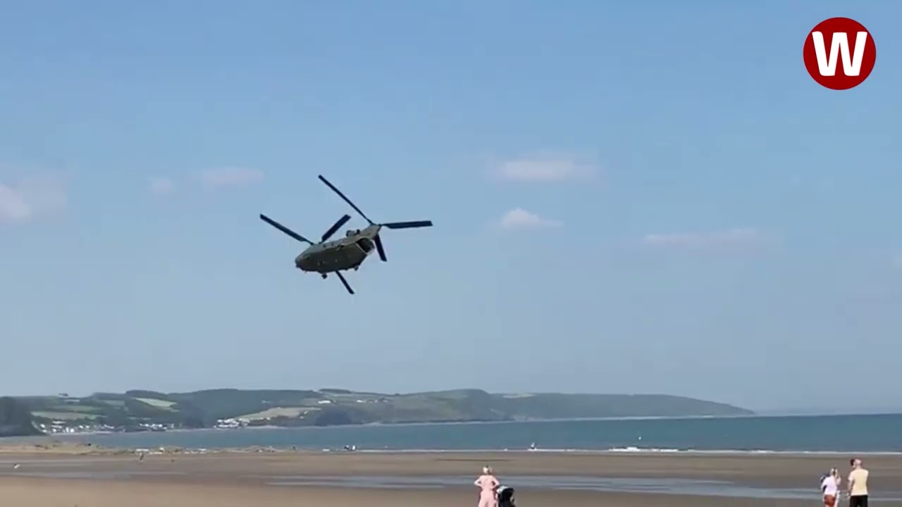 Moment low-flying Chinook helicopter thunders over Welsh beach
