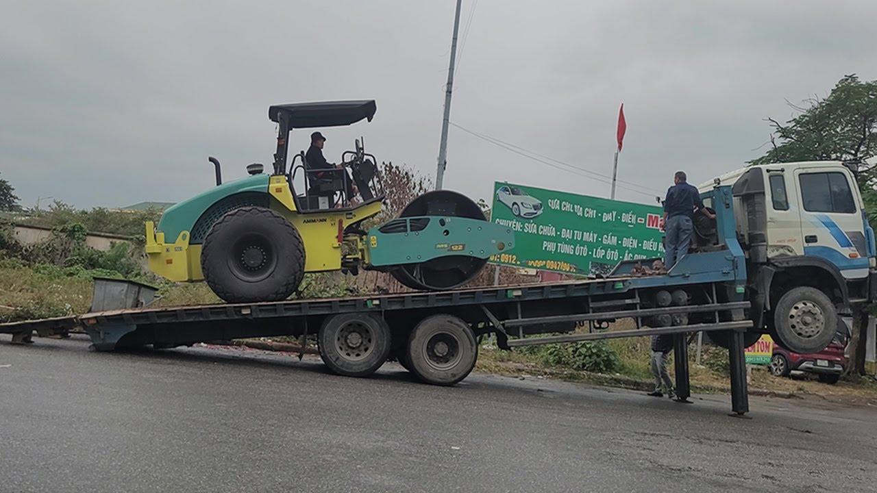 Road Roller Climbing Down The Trailer