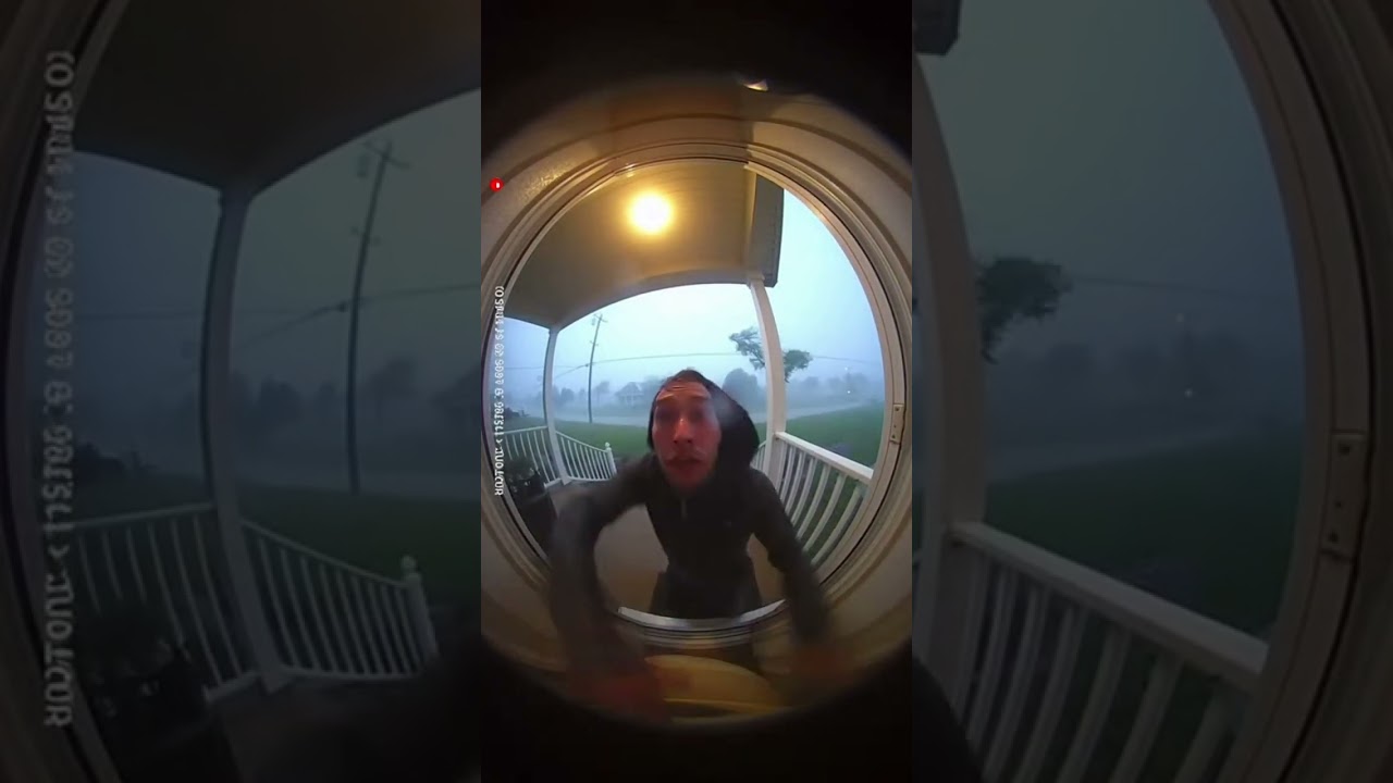 Man trying to get indside his house because of strong rainstorm