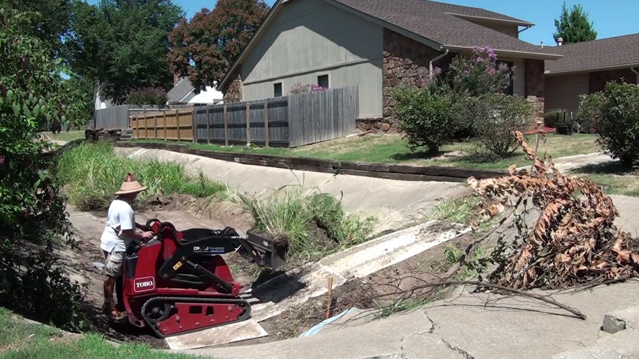 Dredging a concrete channel with a Toro Dingo TX 1000
