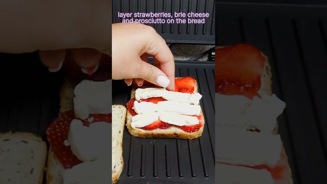 Unusual toast with strawberries, brie cheese and prosciutto