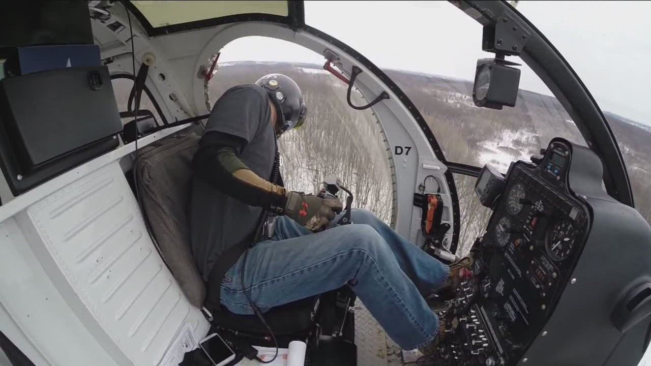 Helicopter with saw helps to trim around power lines