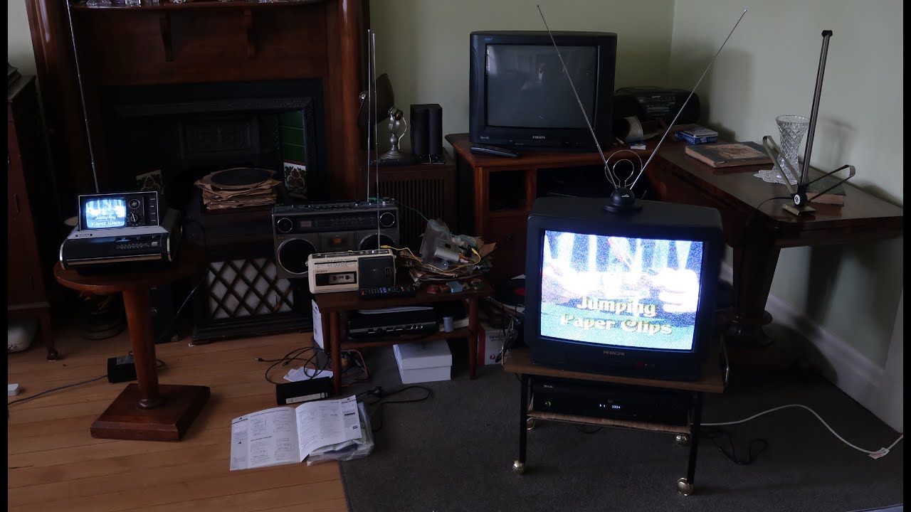 DVD player connected to VCR transmitting to TV connected to RF Modulator transmitting to another TV