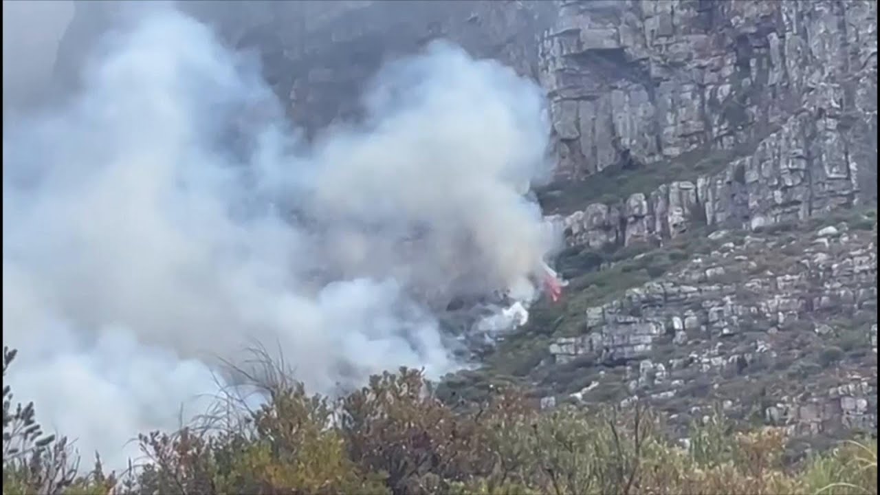 Residents evacuate Tygerberg Nature Reserve area in Cape Town as fire burns on the hillside