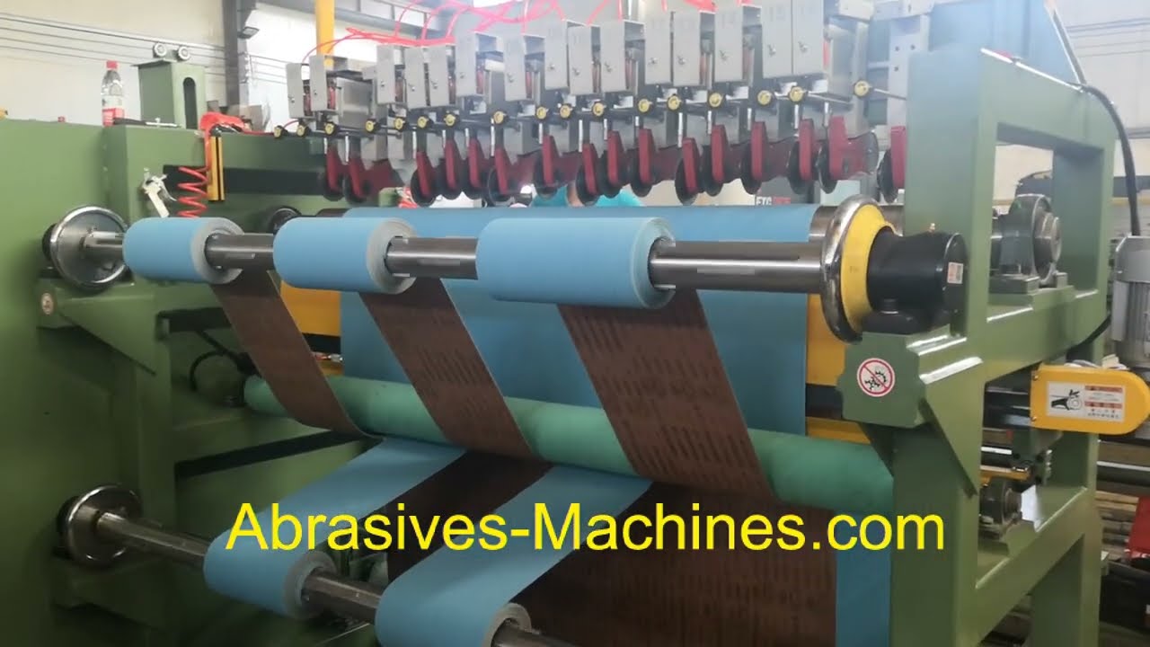 Abrasive jumbo roll slitter for belt converting