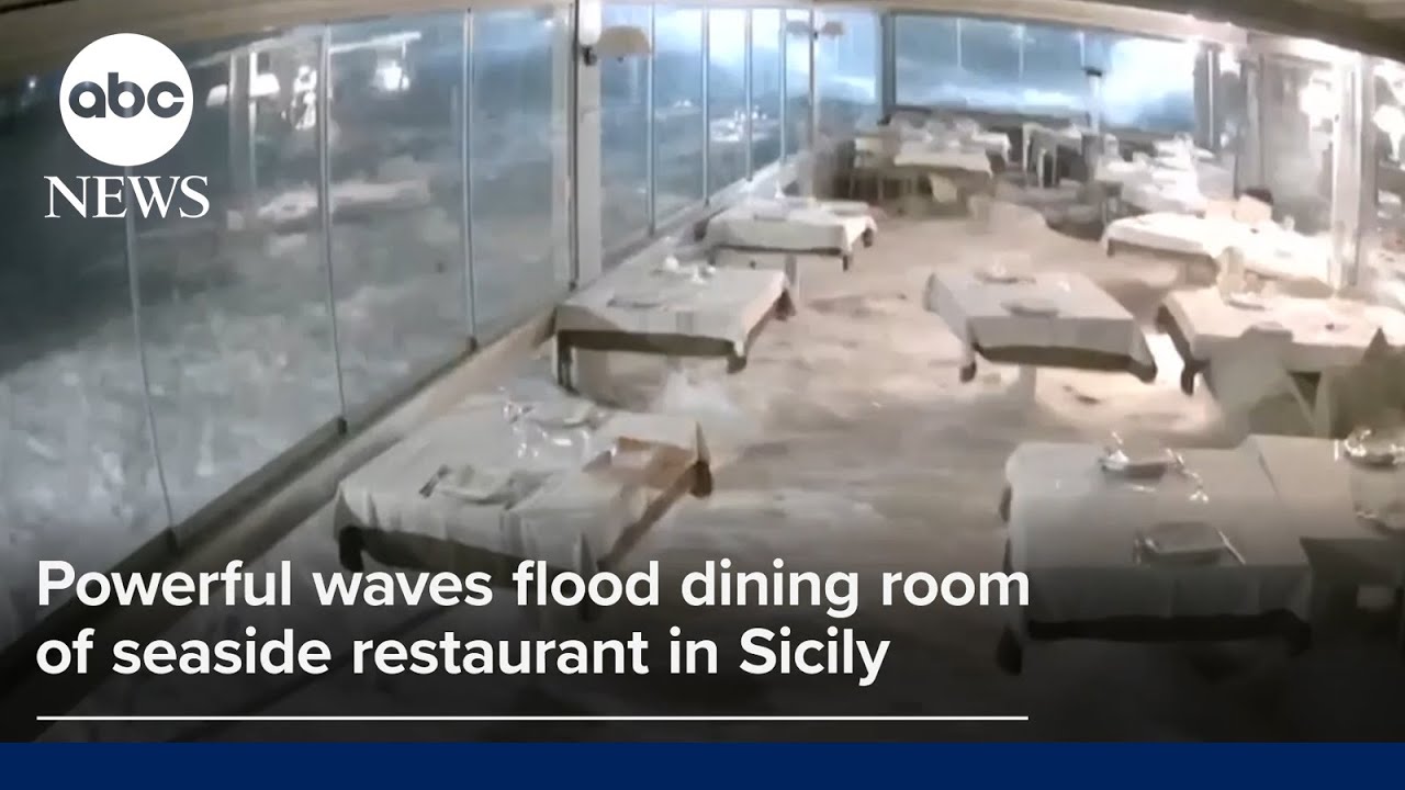 Powerful waves flood dining room of seaside restaurant in Sicily