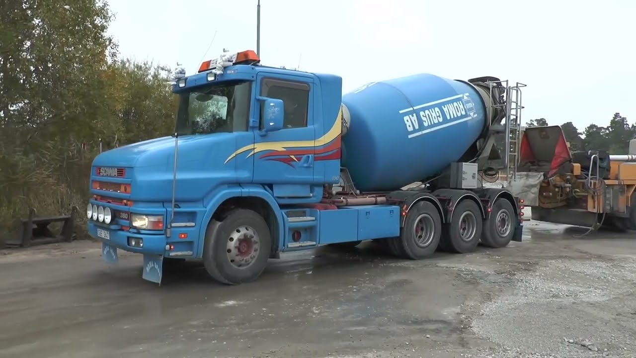 Scania trucks transporting concrete to a large building in 2013