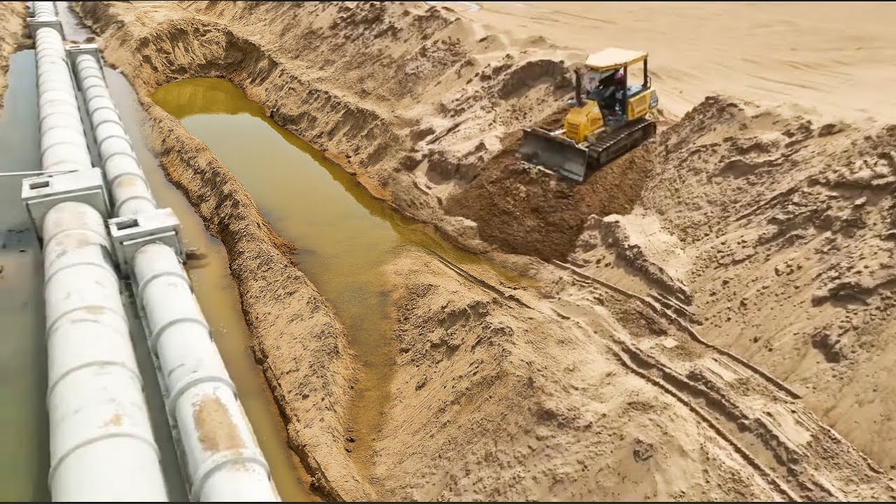Small Bulldozer Clearing Sand Filling Bury The Drain And Sink Land.