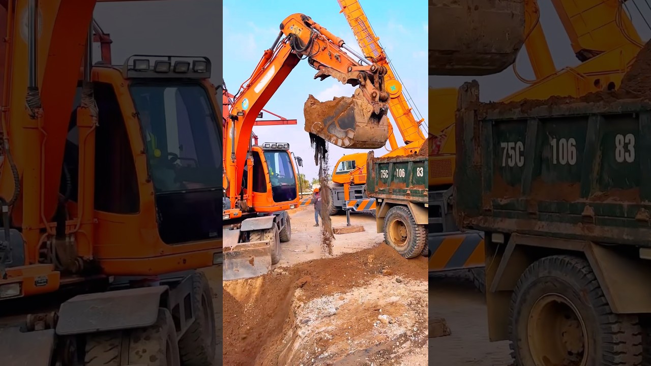 Máy xúc, xe cẩu, xe ô tô tải ben chở đất cùng nhau làm việc. 