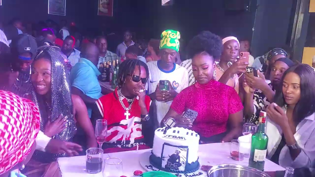 Karole Kasita kisses Fefe Bussi during his birthday celebrations at H20 lounge in Kololo