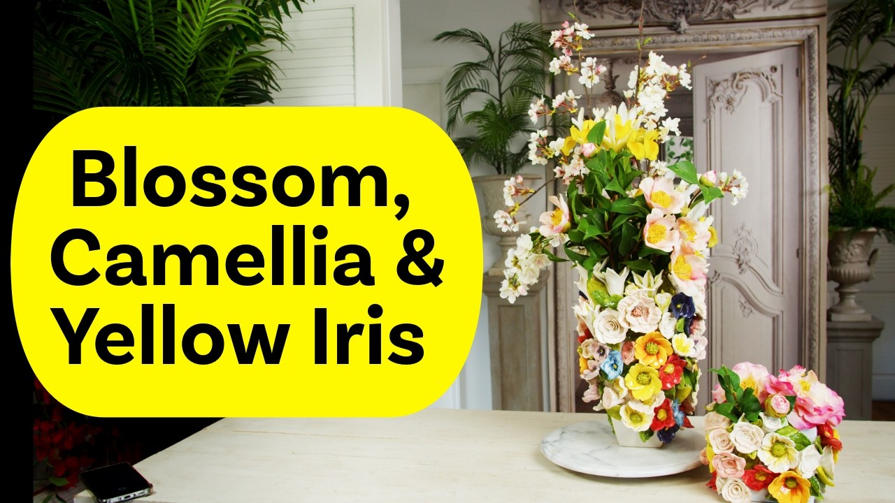 Цветочная композиция из весенних цветов, камелии и жёлтого ириса.