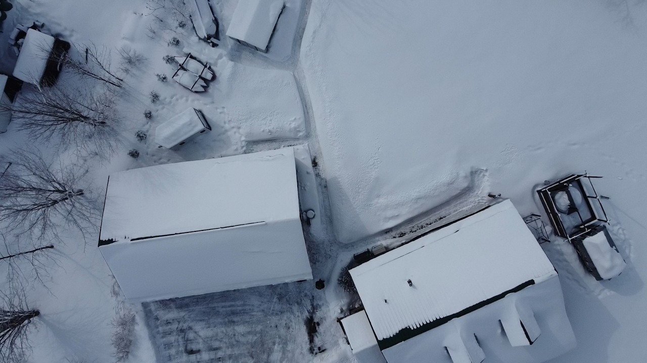 A drone flight around the homestead during the winter - lots of snow.
