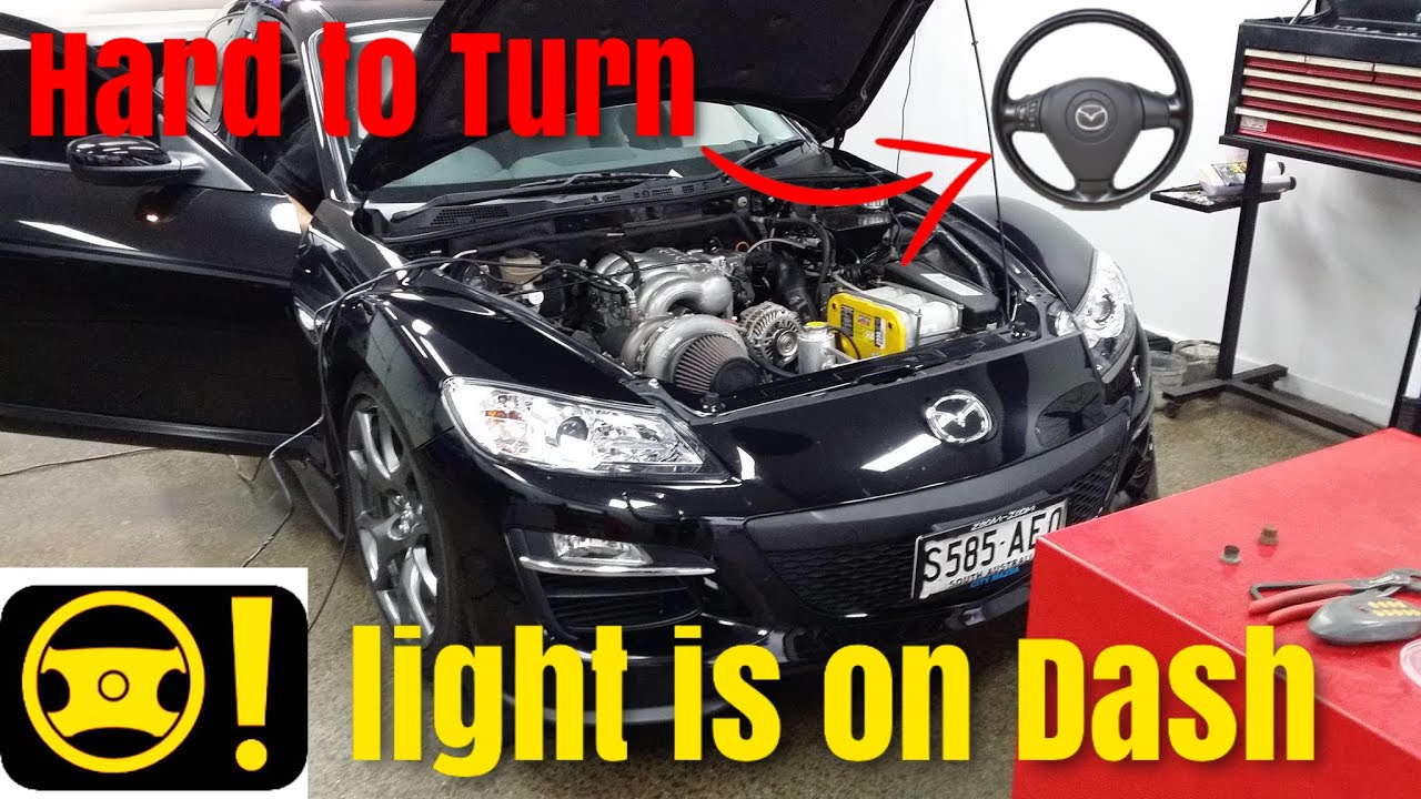 Значок рулевого колеса Mazda RX-8 на панели приборов. Рулевое колесо трудно поворачивается. Пробл...