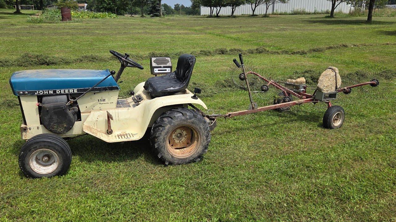 Raking thick grass with acreage estate rake and 1970 John Deere 112 patio
