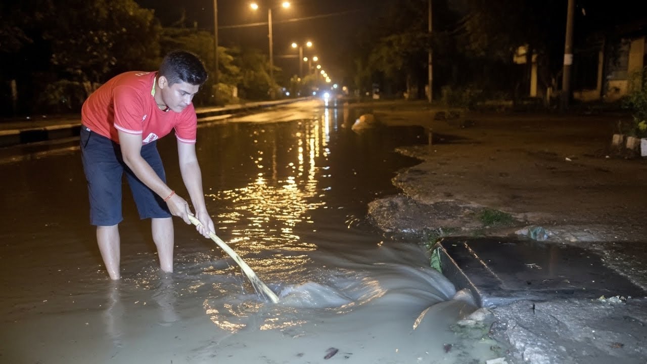 Remove Debris Clogged Culvert On Street At Night