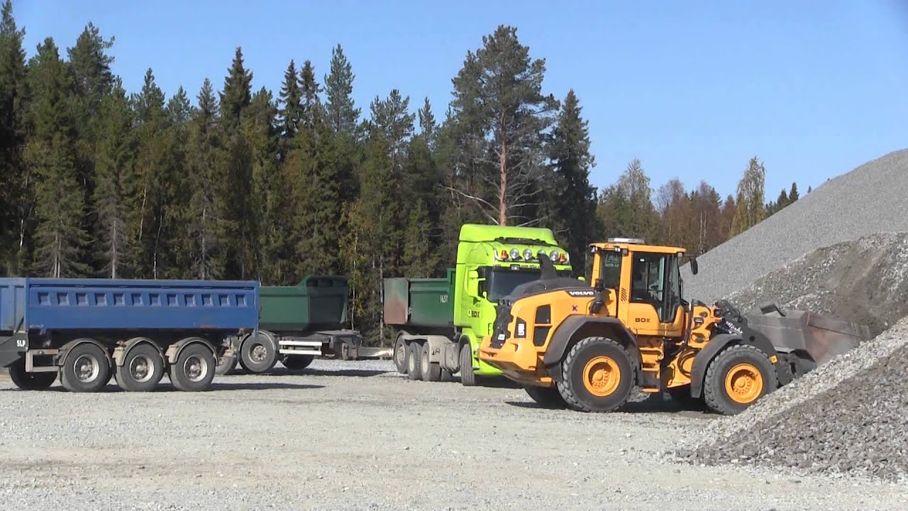 Volvo L90H loading gravel on Scania R480 8x4*4 in a quarry