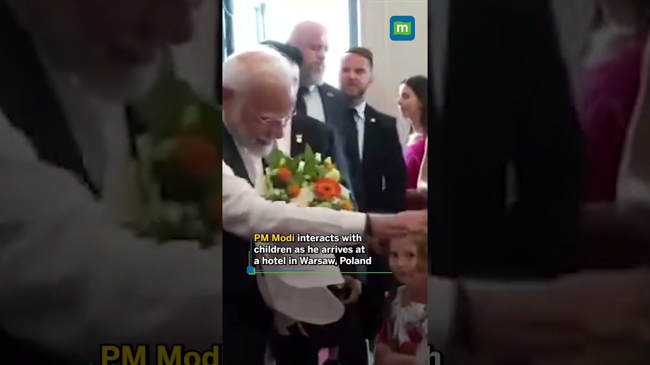 PM Modi interacts with children as he arrives at a hotel in Warsaw, Poland