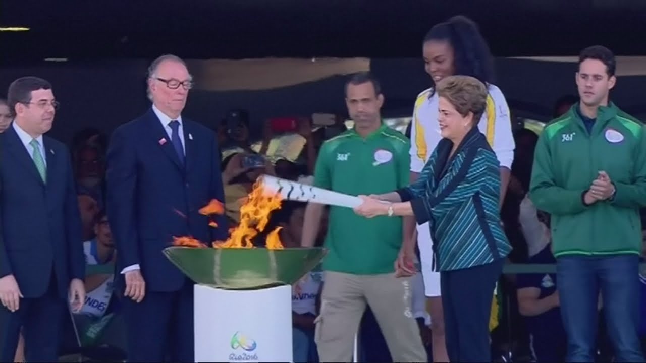 Protestor attempts to grab Olympic torch at Rio 2016 relay