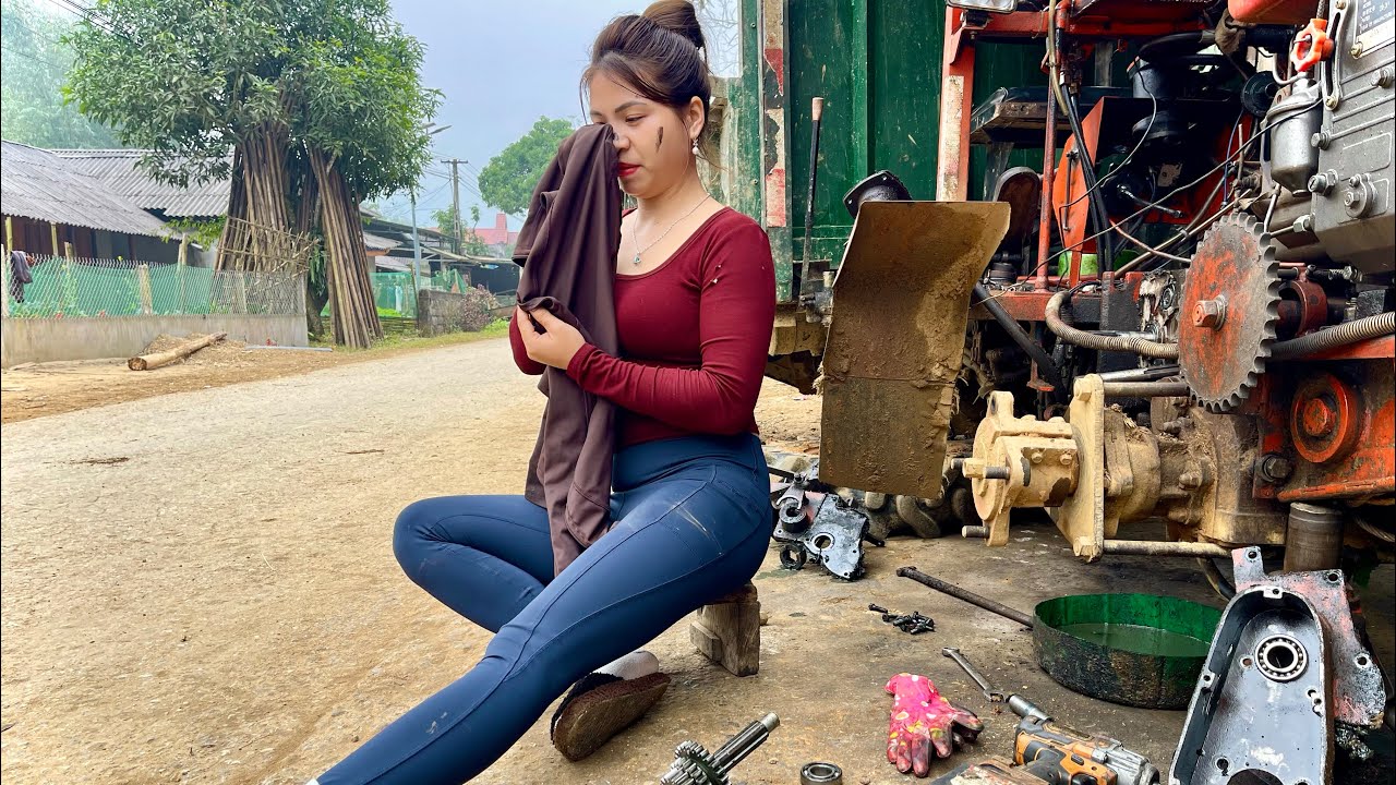 Talented girl: Replacing a broken axle on a tractor.