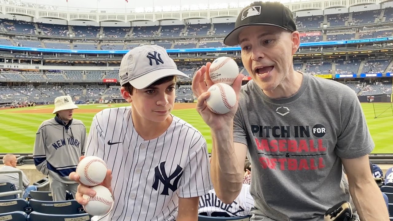 Zack Hample helping a kid catch baseballs at Yankee Stadium
