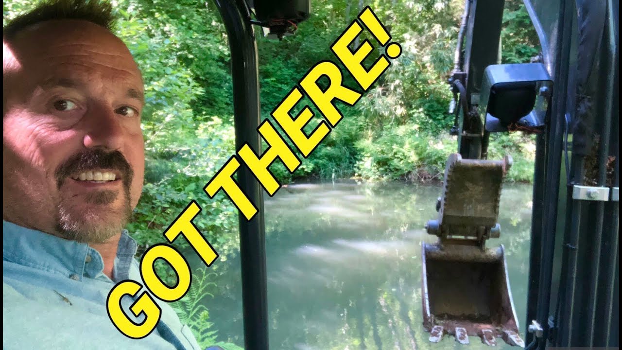 Building a road on steep property to my trout pond with my John Deere 35G Excavator