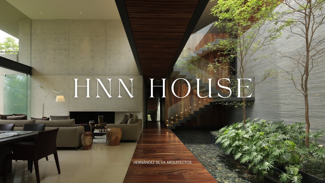 Дизайн современного двухэтажного дома в окружении чистых, красиво благоустроенных зеленых зон