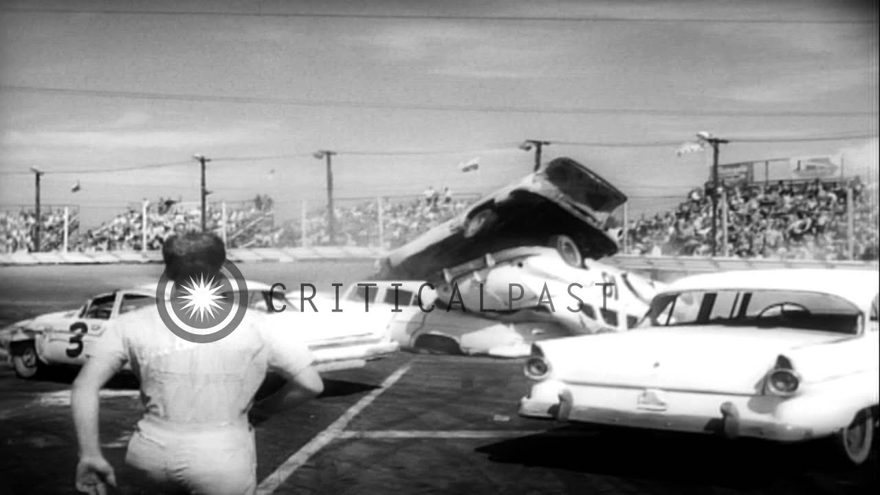 Stunt drivers leap over ramps onto parked cars and roar along two wheels in Demol...HD Stock Footage