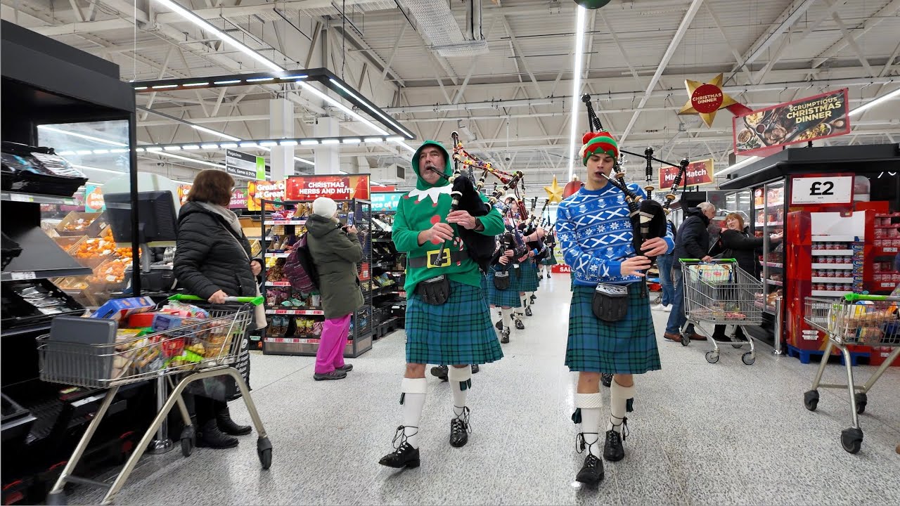 Scotland the Brave as a festive Newtonhill Pipe Band march through Asda in Portlethen at Christmas