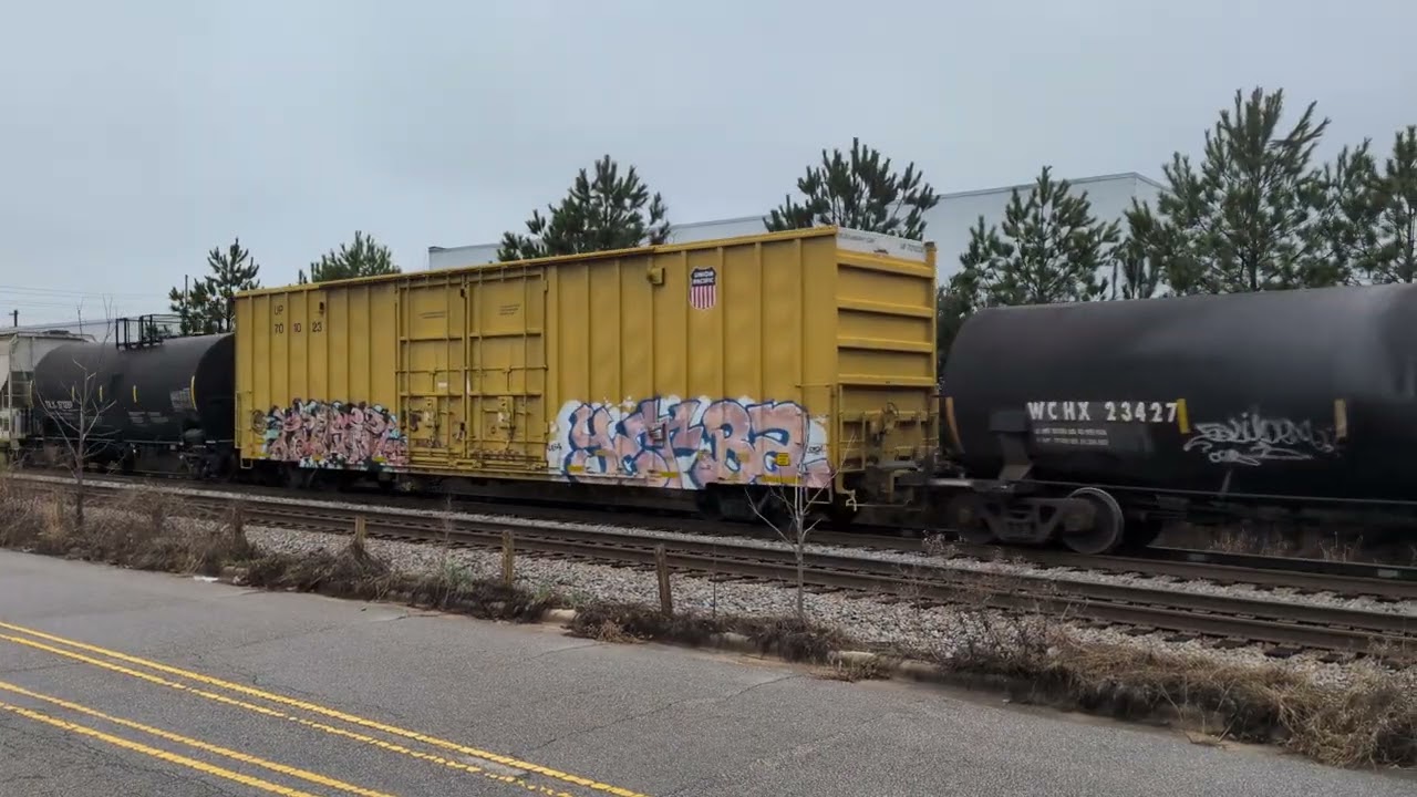 CSX 3104 leads a good sized north bound mixed freight down Winslow Street in Fayetteville 2/27/2026