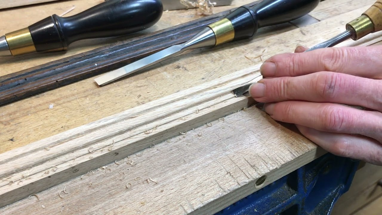 Cutting moulding with hand tools.