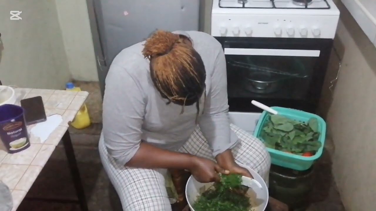 Making ugali, meat and vegetables on a rainy evening.
