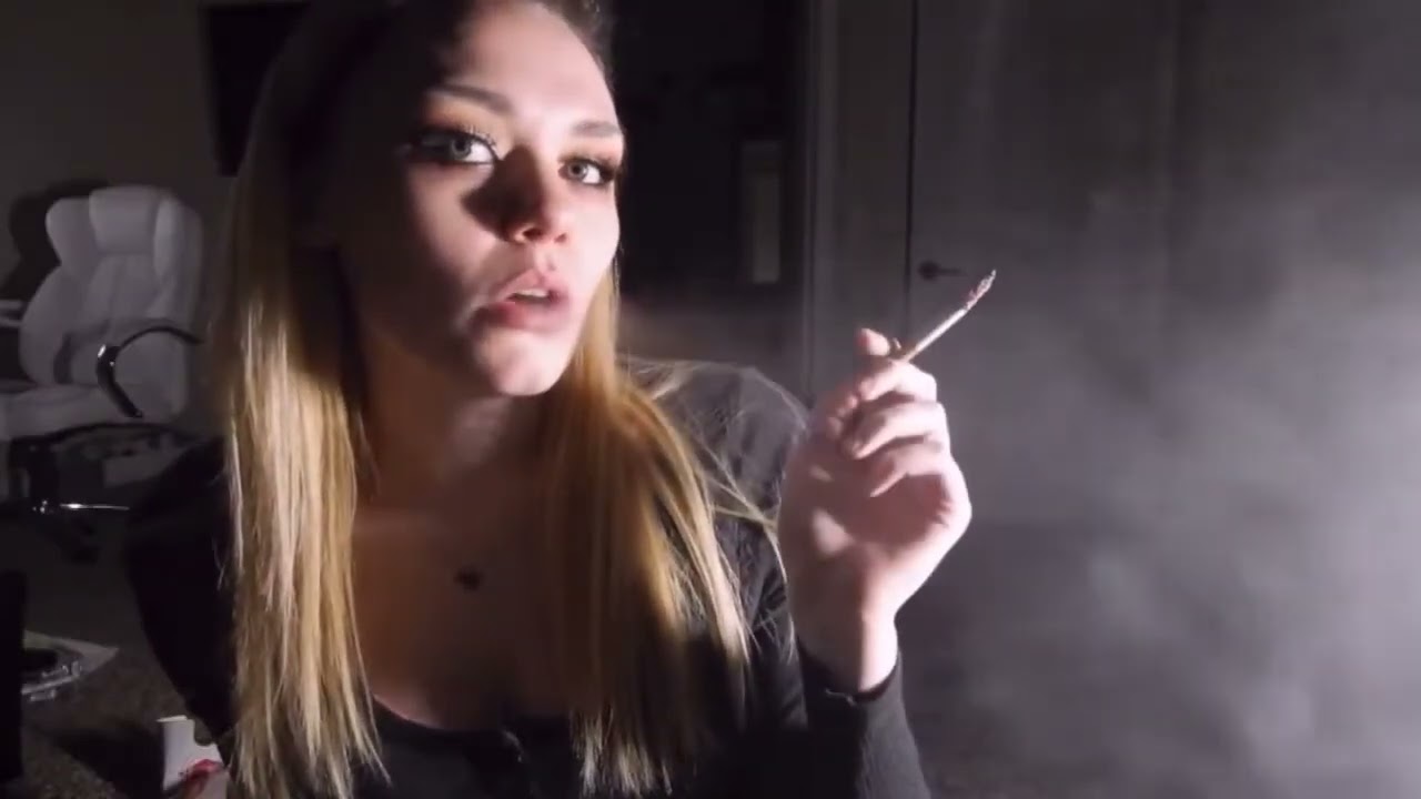 Kayley smoking two cigarettes in a row indoors