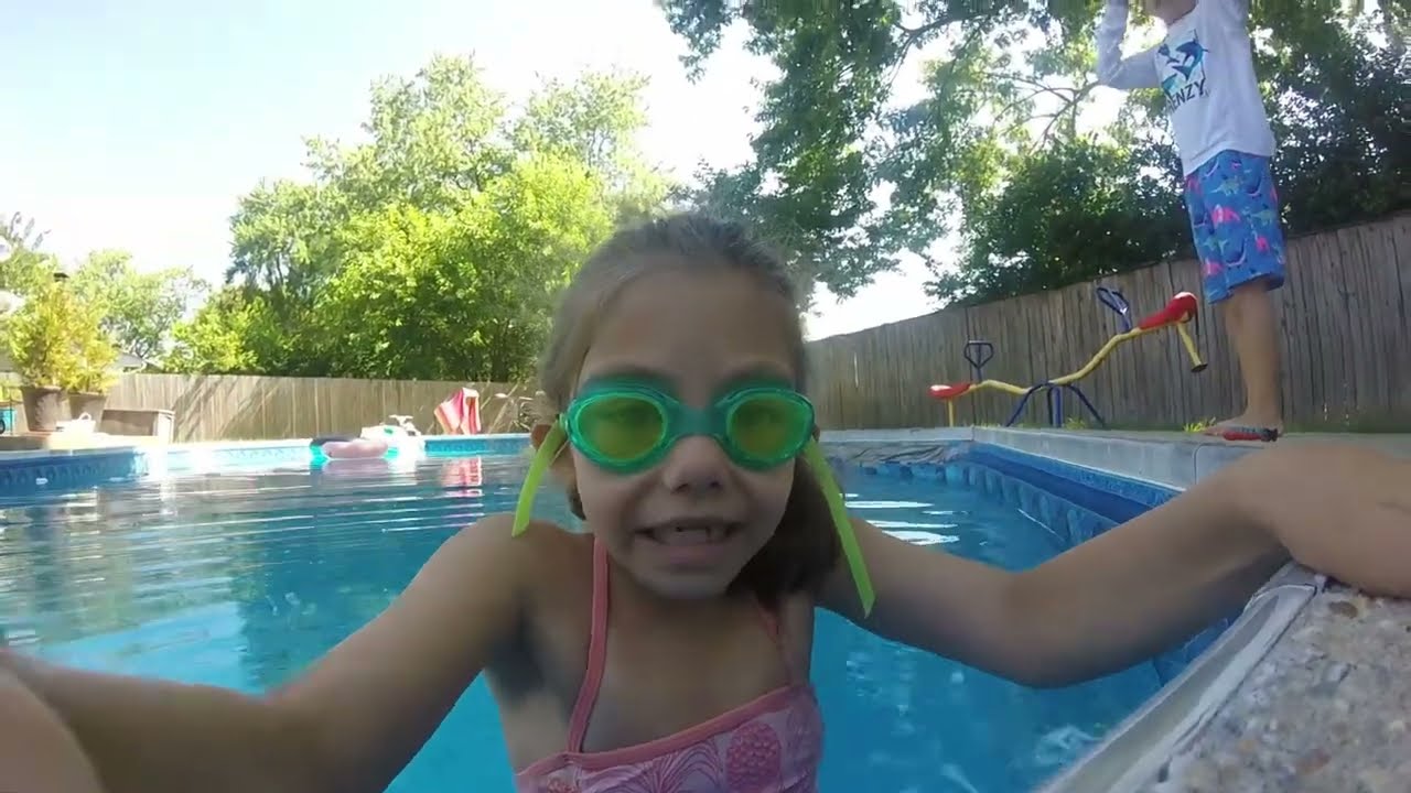 Kids Swimming in a 8 foot pool with a GoPro video camera on a sunny day.