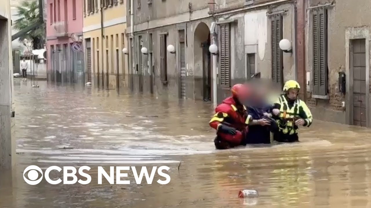 Watch: Firefighters slog through waist-high floodwaters near Milan