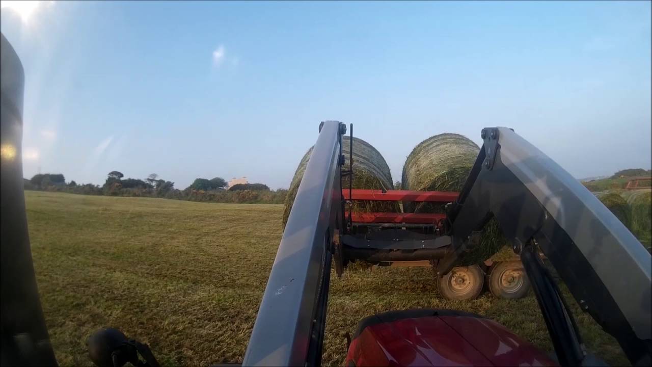 Loading silage bales with a Valtra T144 active and Grays triple bale spike