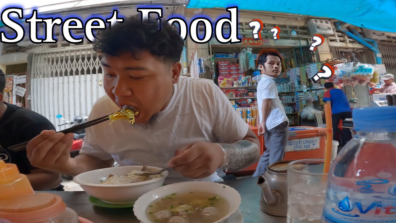 Cambodian Street Breakfast / Man watching me eat