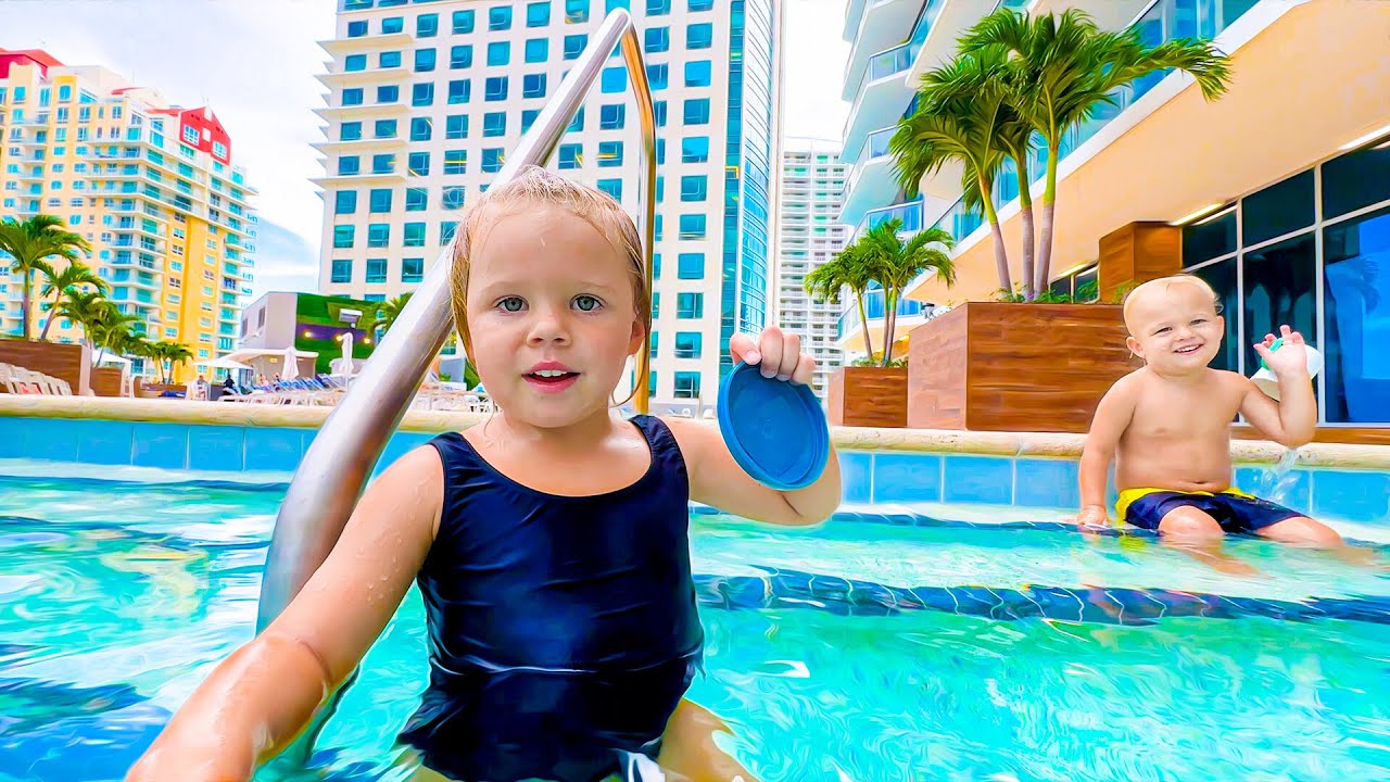 Little Naomi is enjoying the pool with her baby brother.