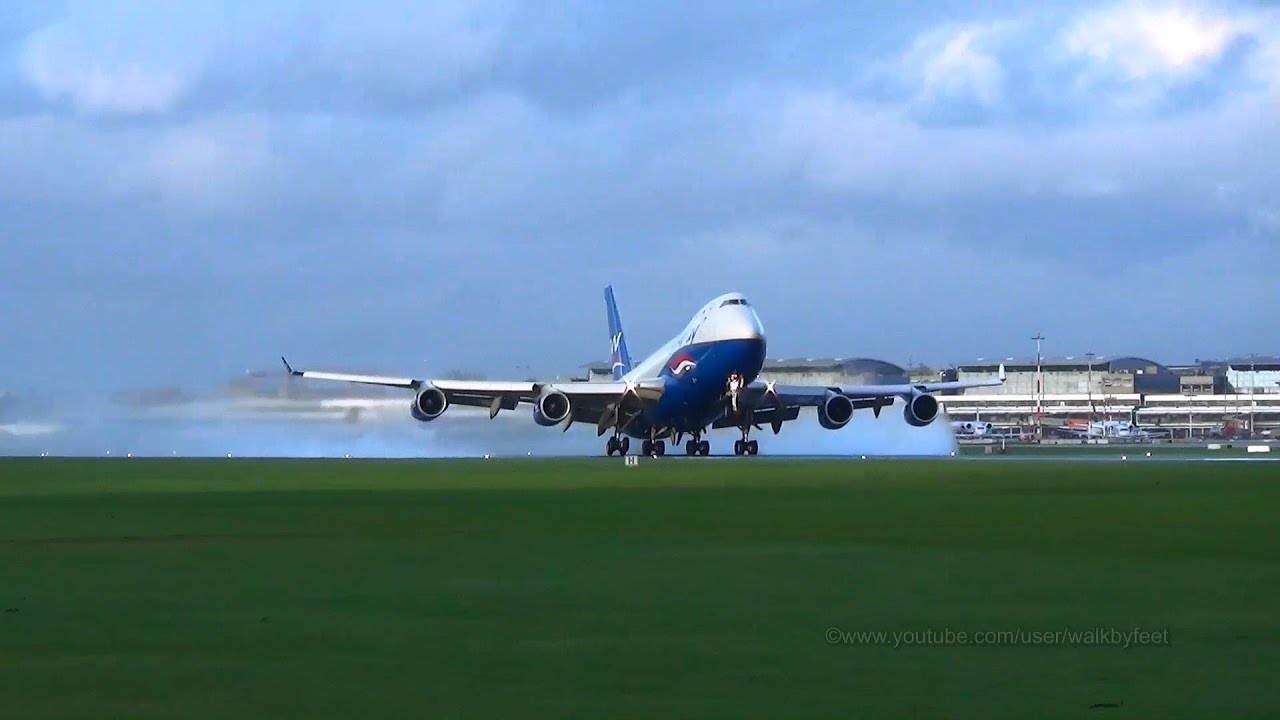 Landing and wet runway takeoff of Silk Way Airlines Boeing 747-4R7F 4K-SW008 at Hamburg Airport