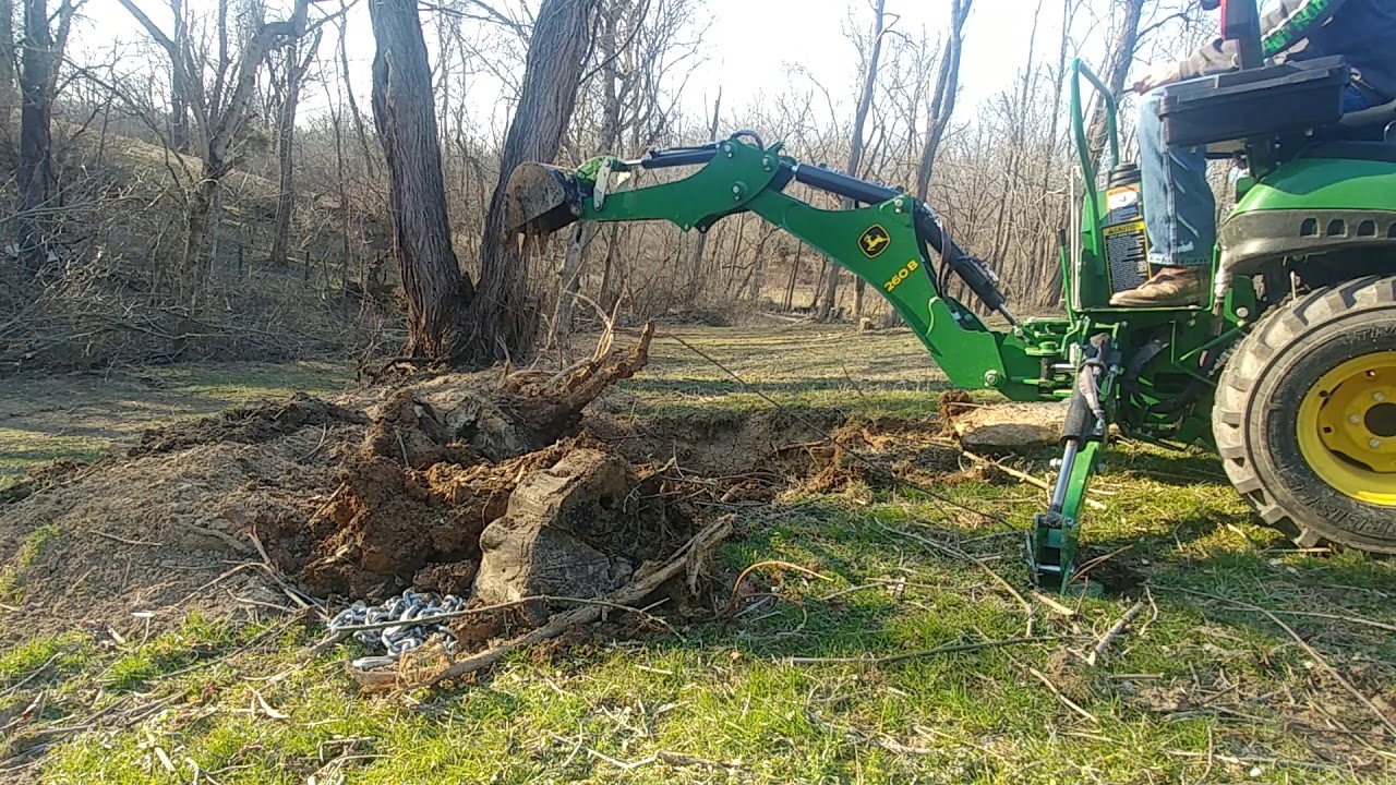 John Deere 1025R With a 260B backhoe doing Stump Removal