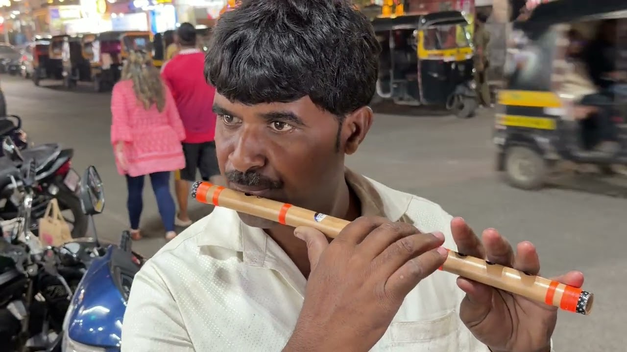 ￼ Flute seller plays a flute
