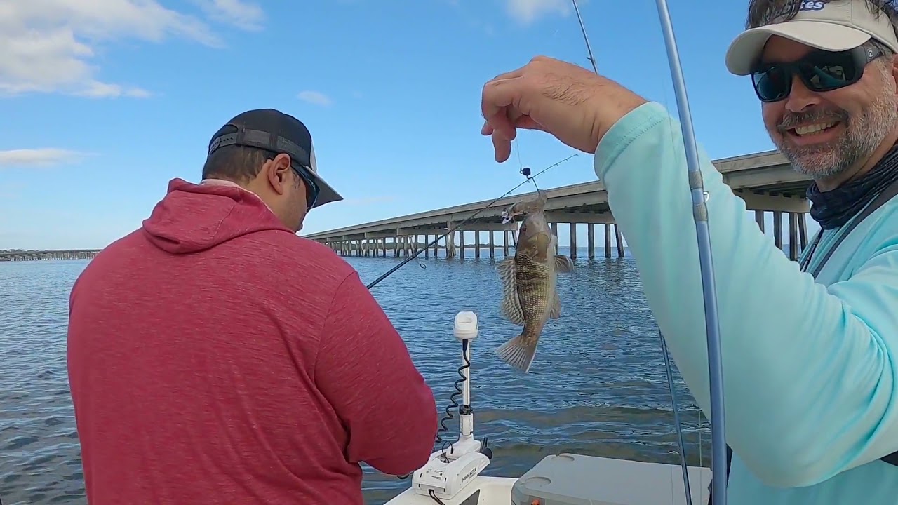 Trash talking angler catching trash fish.
