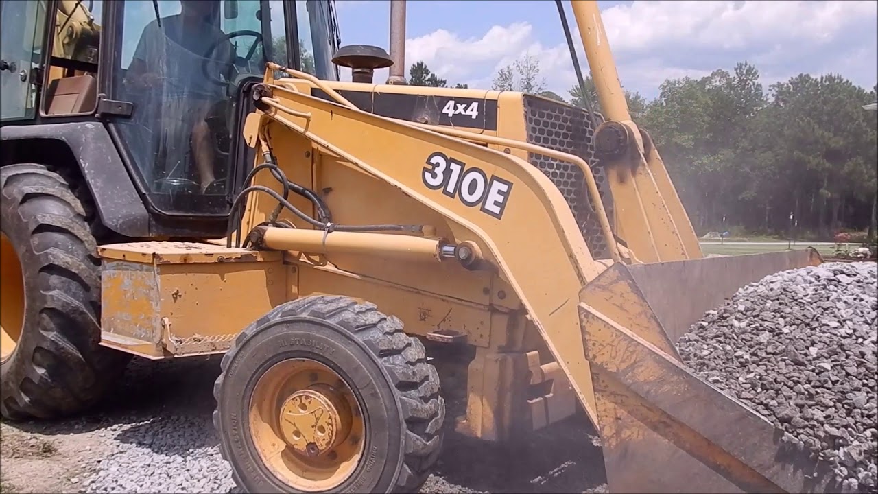 Backhoe Spreading Gravel