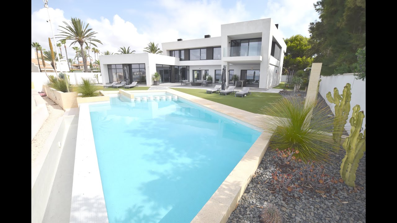 Frontline detached villa overlooking Cabo Roig beach.