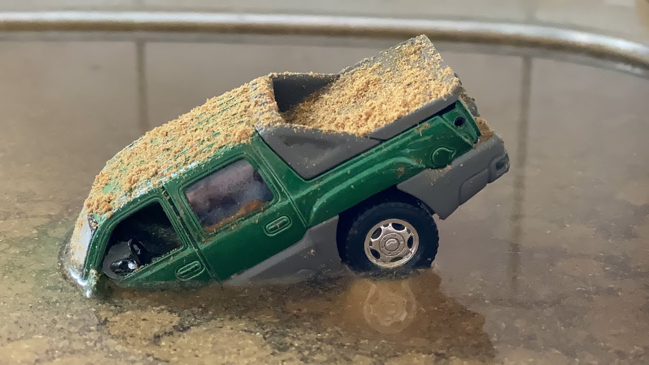 Model Cars falling into cloudy water
